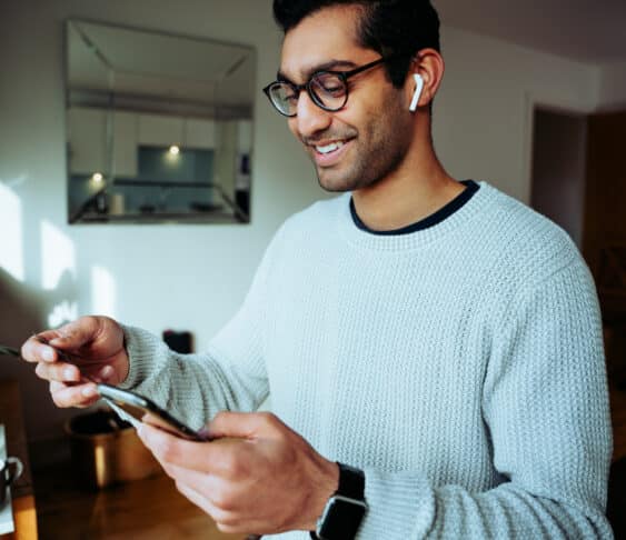 happy man using ebay on his mobile device